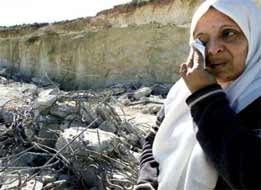 This woman has just watched her home being turned to rubble by racist agressors, her life in ruins because of our failure, in the 'civilised world' to stand by our stated principles. Who will give her justice?