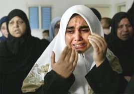 The sister of Palestinian teenager Zaki Alshareef, weeps during his funeral, after he was killed when Israeli forces razed scores of homes in the Rafah refugee camp.