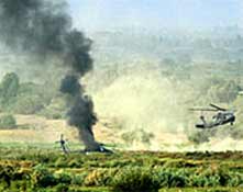 A USA helicopter burns after an RPG attack - one soldier was injured in this attack.