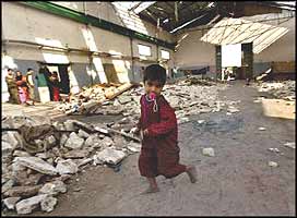 Homeless Iraqi children use the relative safety of a warehouse, and all of their imagination, to pretend that the world really is a place for them to grow up in.