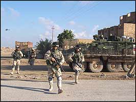 Under orders from their political masters, occupying forces occupy almost every street corner of Samarra.